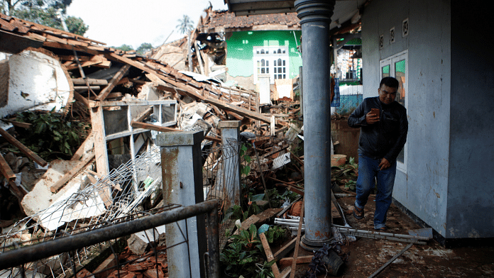A man inspects his house that got destroyed in the earthquake in West Java province, Indonesia on 22 November 2022 | Photo: Reuters/Ajeng Dinar Ulfiana