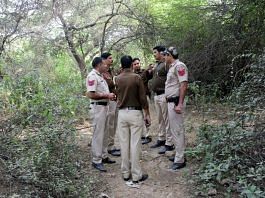 Police personnel at jungle area during a search Tuesday to locate body parts of the victim | ANI