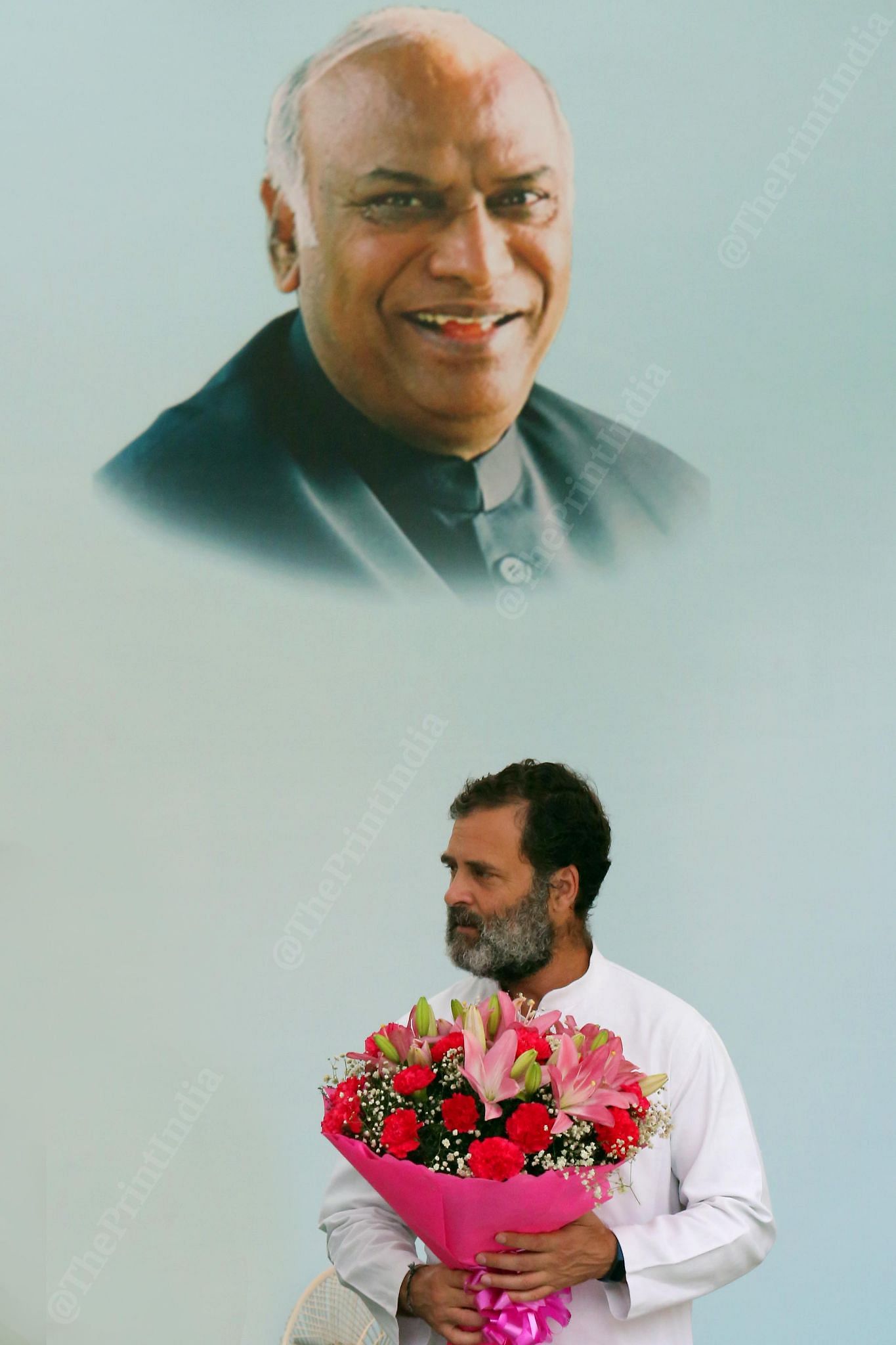 November 2022: At Congress President Mallikarjun Kharge’s oath taking ceremony, party leader Rahul Gandhi waits with flowers on the stage in Delhi | Praveen Jain, ThePrint