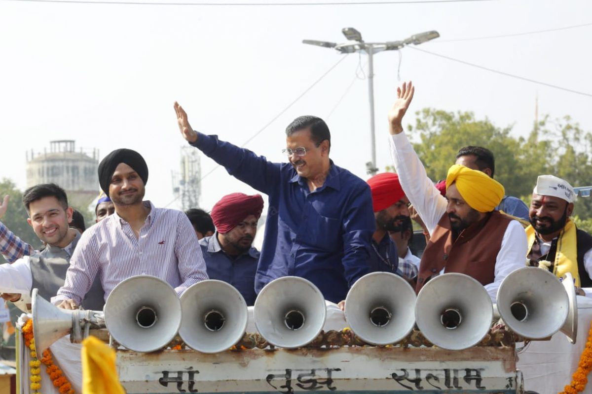 Kejriwal and Punjab CM Bhagwant Mann wave at the crowd | Photo: Praveen Jain | ThePrint