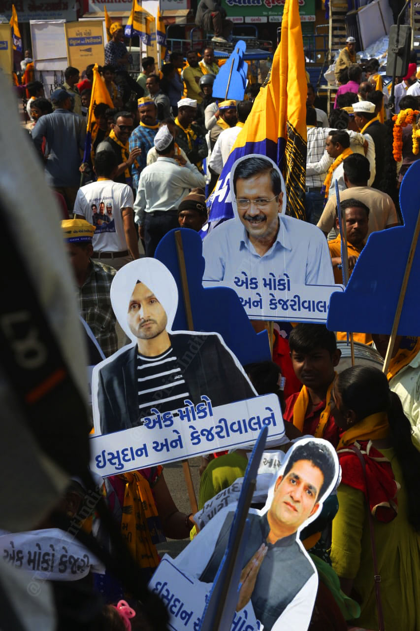 People holding placards of AAP leaders, including Isudan Gadhvi | Photo: Praveen Jain | ThePrint