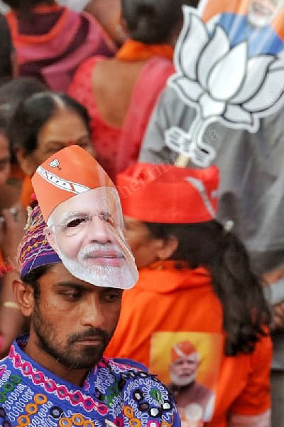 BJP supporter wearing Modi mask during roadshow | Photo: Praveen Jain | ThePrint