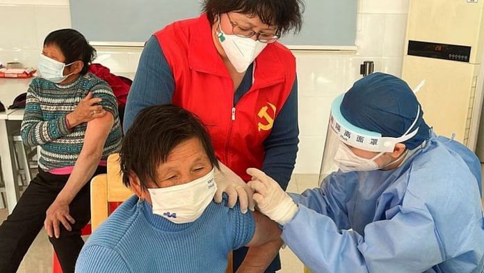 A medical worker administers a dose of a vaccine against coronavirus disease (COVID-19) to an elderly resident, during a government-organized visit to a vaccination center in Zhongmin village on the outskirts of Shanghai, China | REUTERS/Brenda Goh