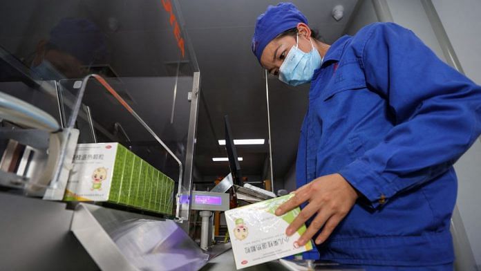 An employee works at the production line of a fever medicine at a Guizhou Bailing plant amid the coronavirus disease (Covid-19) outbreak, in Anshun, Guizhou province | cnsphoto via Reuters