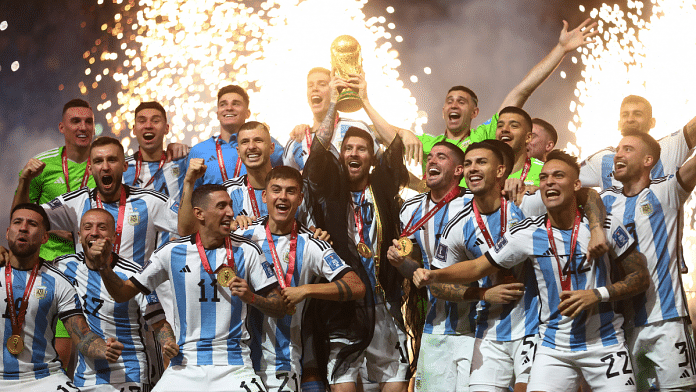 Argentina's Lionel Messi celebrates with the trophy and teammates after winning the World Cup | Reuters