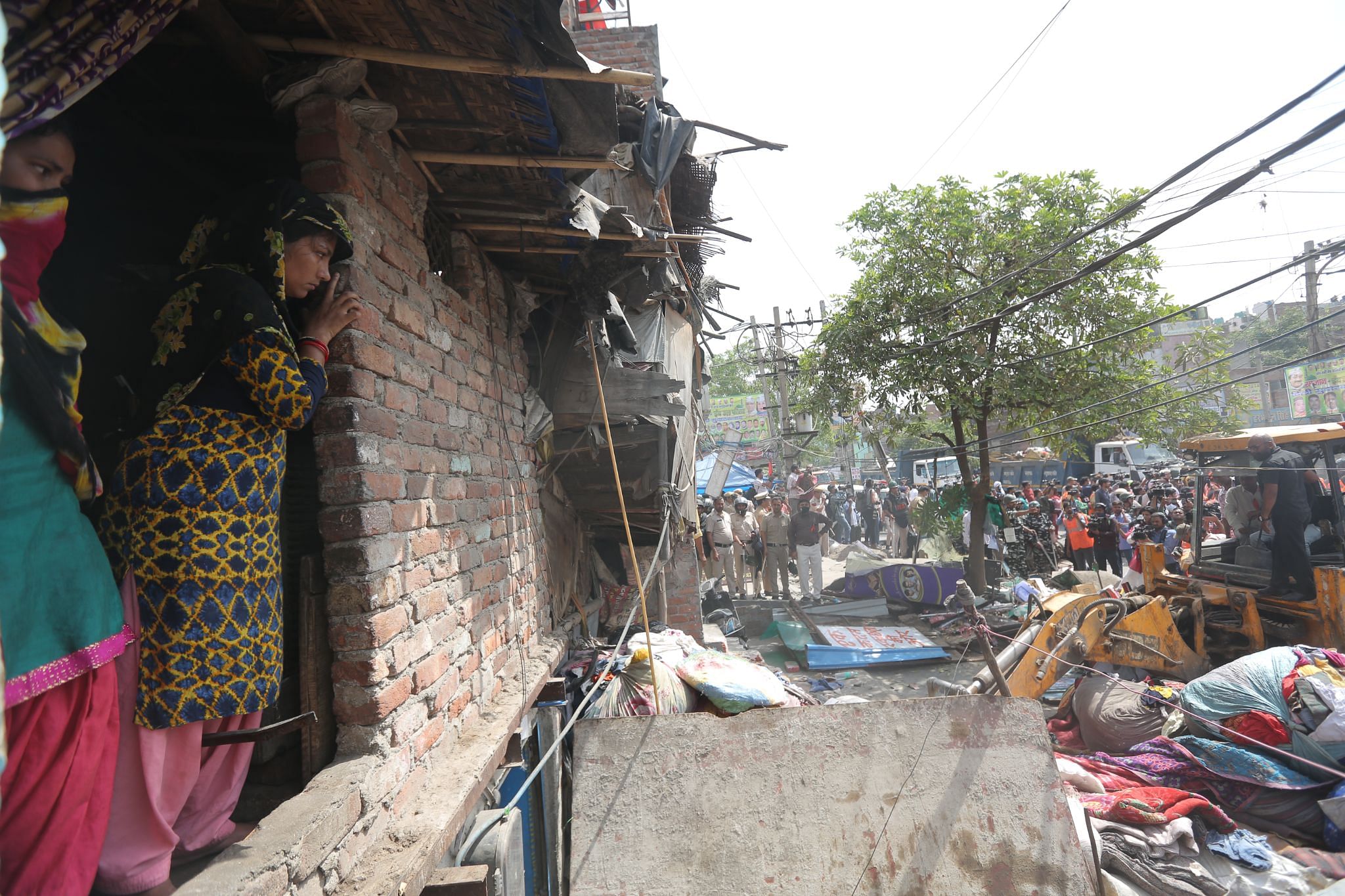June 2022: Women watch a house being demolished from the balcony | Suraj Singh Bisht, ThePrint