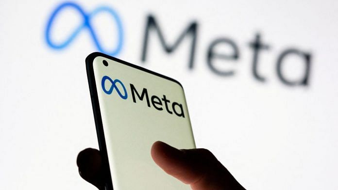 Woman holds smartphone with Meta logo in front of a displayed Facebook's new rebrand logo Meta in this illustration picture taken 28 October 2021 | Reuters/Dado Ruvic/Illustration/File Photo