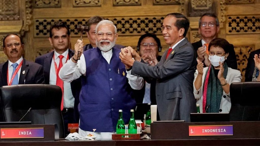 PM Narendra Modi and Indonesia's President Joko Widodo hold hands during the handover ceremony at the G20 Leaders' Summit in Nusa Dua, Bali, on 16 November 2022 | Reuters/Willy Kurniawan/Pool