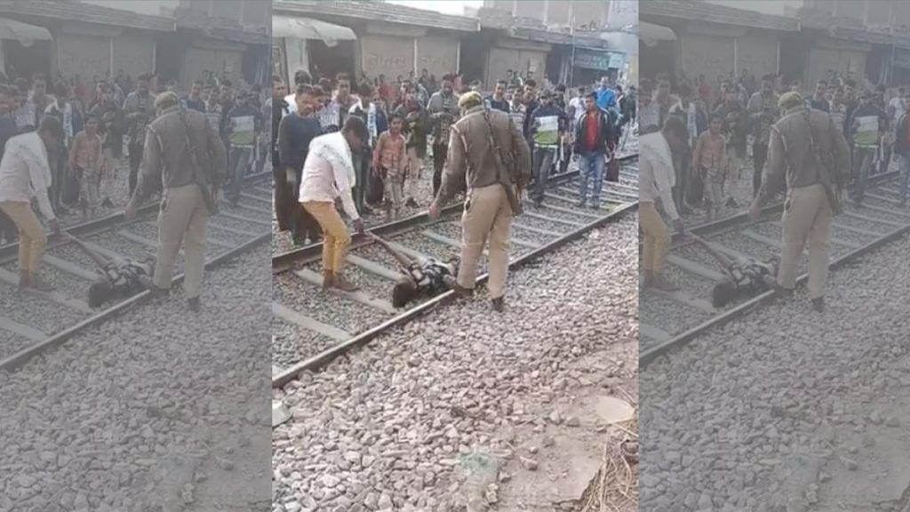 Screengrab from an eyewitness video of the incident shows Arsalan’s brother and a police officer moving him off the tracks | By special arrangement