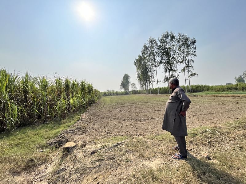 The field where Vikrant hanged himself, one of his uncles standing at one corner. The family got rid of all the rose wood trees, as it would remind them of the horrible visual of their son hanging | Jyoti Yadav, ThePrint