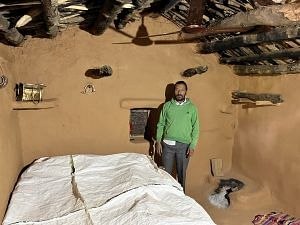Sumit Kumar's father stands next to the bed where he hanged himself from a ceiling fan | Jyoti Yadav, ThePrint
