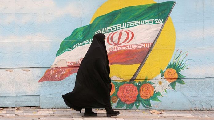 A woman walks after the morality police shut down in a street in Tehran, Iran 6 December, 2022 | Majid Asgaripour/WANA (West Asia News Agency) via Reuters