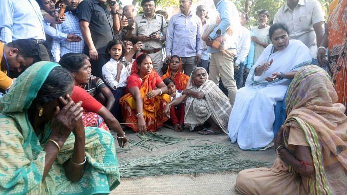 File photo of TMC chief Mamata Banerjee with villagers | ANI