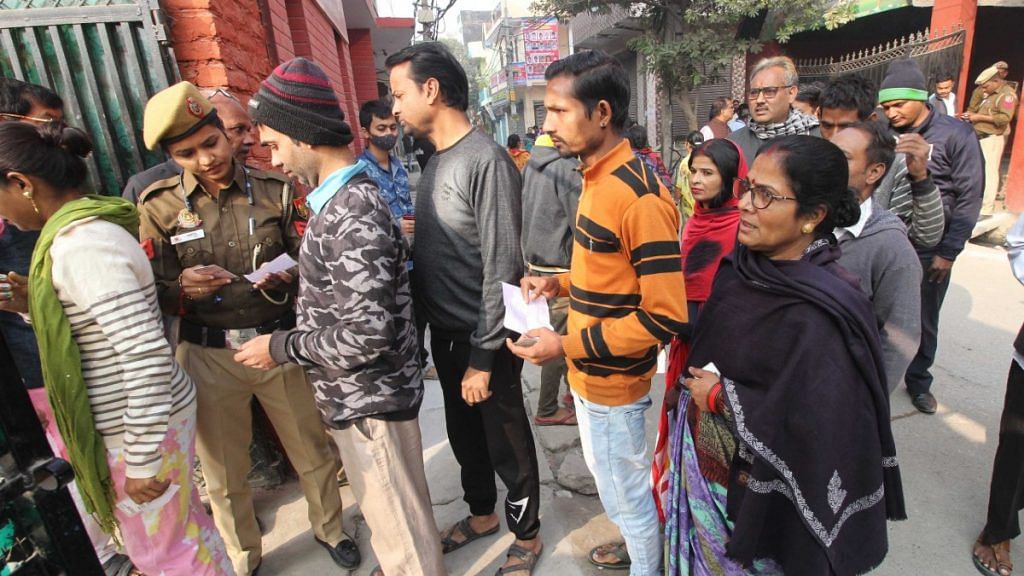 Voters queue outside polling station in Delhi to cast their vote for MCD elections Sunday | Suraj Singh Bisht | ThePrint
