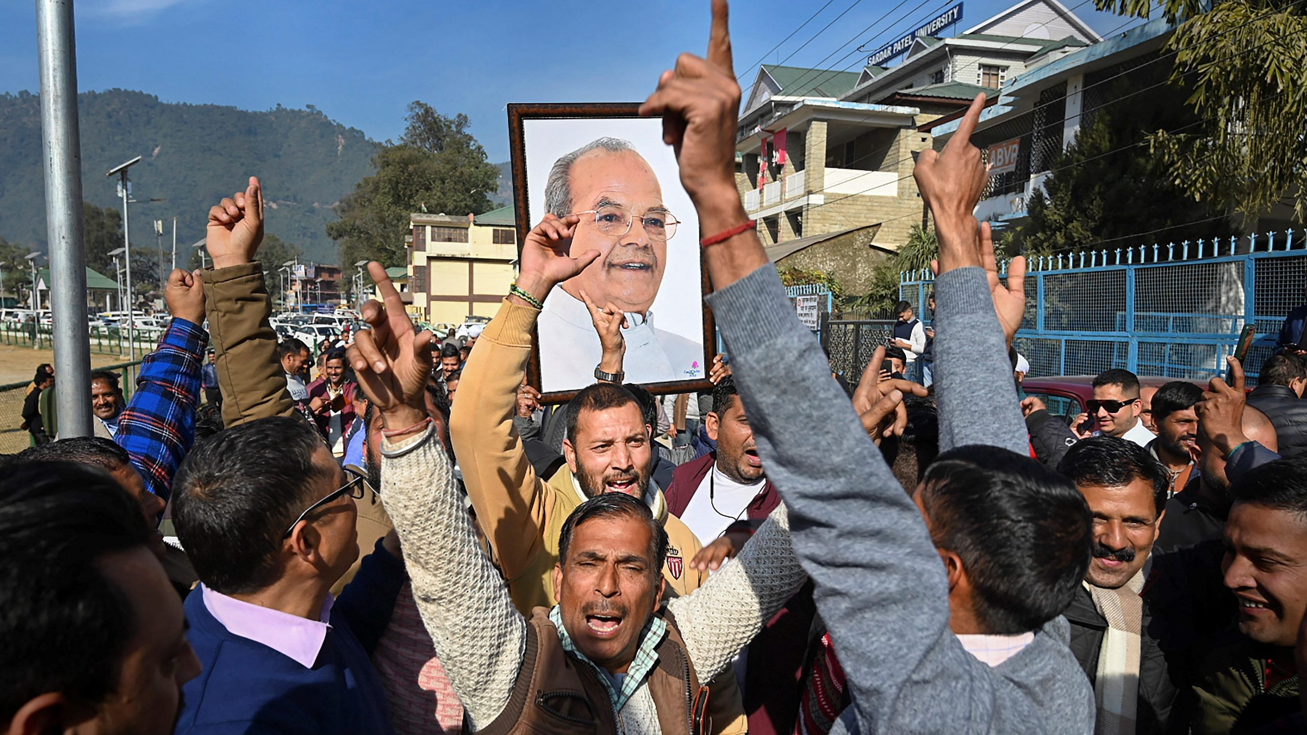 BJP supporters carry a picture of the late Sukh Ram to celebrate his son Anil Sharma's probable victory in the Assembly polls in Himachal Pradesh's Mandi, 8 December, 2022 | Photo: PTI