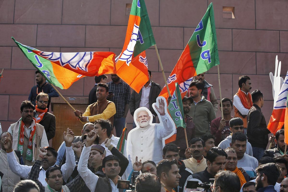 BJP supporters wave the party flag at the headquarters in New Delhi | Photo: Suraj Singh Bisht | ThePrint