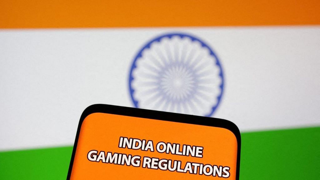 The words "India online gaming regulations" are displayed in front of an Indian flag in this Illustration taken 14 September 2022 | Reuters/Dado Ruvic/Illustration