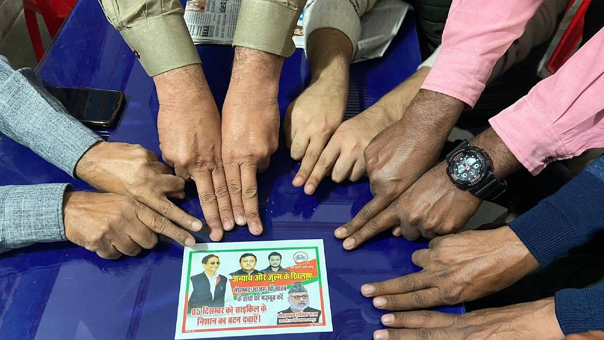 SP members hold out their index fingers to show that there was no mark of the indelible ink to indicate that they didn't vote | Photo: Madhuparna Das | ThePrint