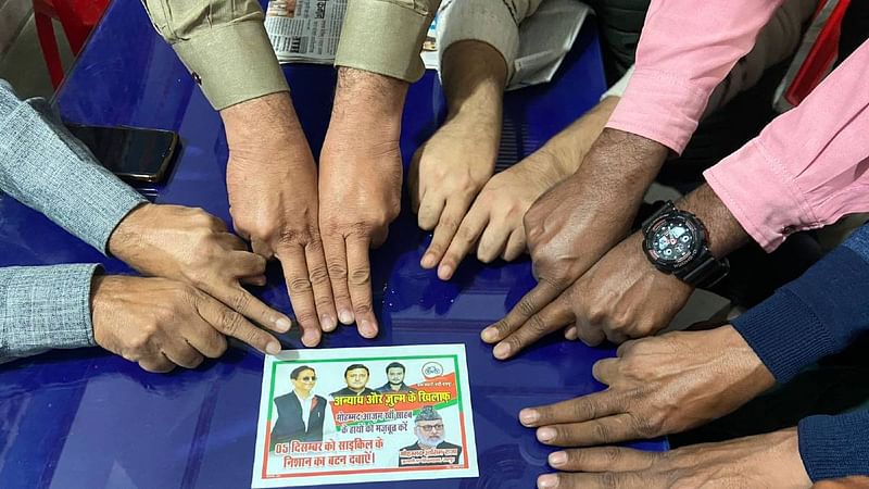 SP members hold out their index fingers to show that there was no mark of the indelible ink to indicate that they didn't vote | Photo: Madhuparna Das | ThePrint