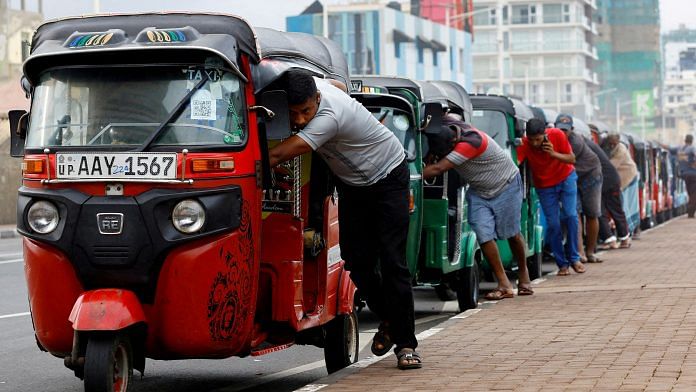 File photo of drivers push auto rickshaws in a line to buy petrol from a fuel station amid Sri Lanka's economic crisis, in Colombo, Sri Lanka on 29 July 2022 | Photo: Reuters/Kim Kyung-Hoon/