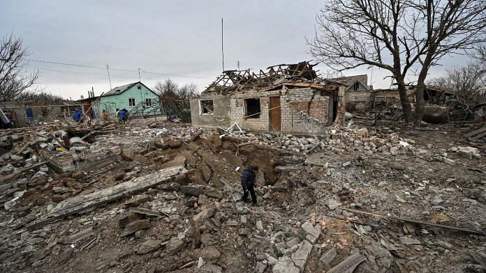 A local resident inspects a crater left by a Russian military strike, as their attack in Ukraine continues, in the village of Kupriianivka, Zaporizhzhia region, Ukraine 7 December, 2022 | Reuters/Stringer
