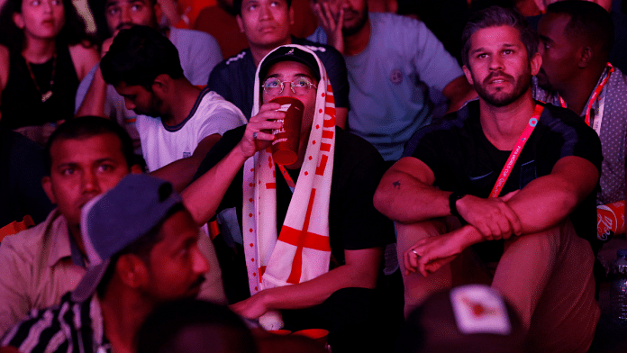 Al Bidda Park, Doha, Qatar | 25 November, 2022 | A fan drinks a Budweiser beer during the match between England and United States | Reuters/Albert Gea