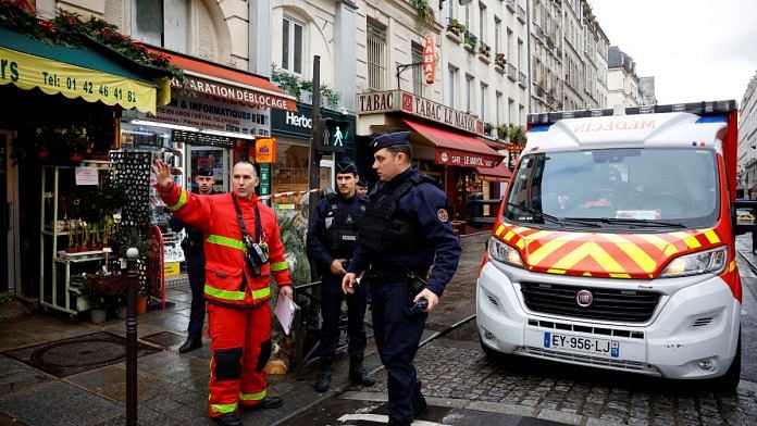 French police and firefighters secure a street after gunshots were fired killing two people and injuring several in a central district of Paris, France on 23 December, 2022 | Reuters