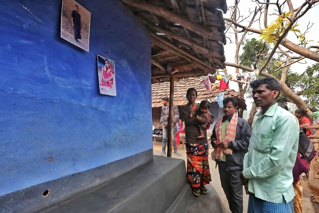 Father Suraj Pahadiya looks at the blue wall where he put pictures of his daughter | Praveen Jain, ThePrint