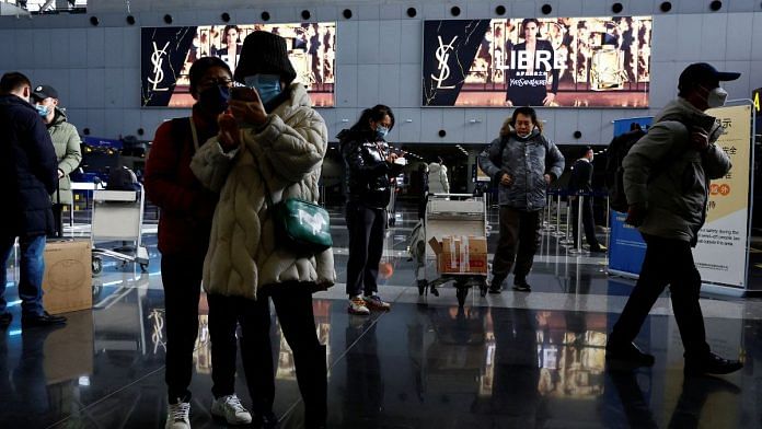 File photo of travellers stand by their luggage at Beijing Capital International Airport, amid the coronavirus disease (Covid-19) outbreak in Beijing, China | Reuters/Tingshu Wang