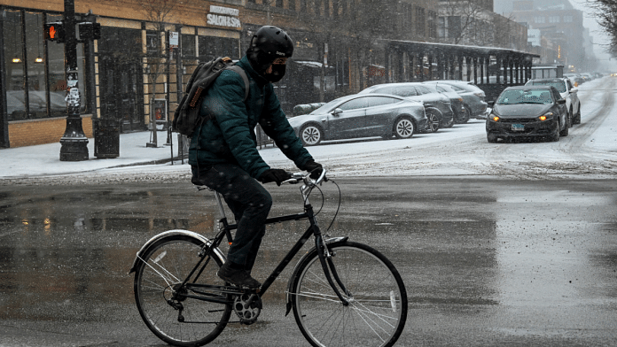 A bicyclist makes his way along Halsted Street during a cold weather front as a weather phenomenon known as a bomb cyclone hits the Upper Midwest, in Chicago | ReutersMatt Marton
