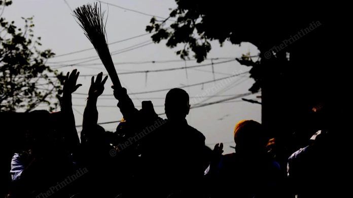 Arvind Kejriwal holds a 'jhadu' at the roadshow | Photo: Praveen Jain | ThePrint