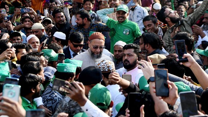 File photo of AIMIM chief Asaduddin Owaisi surrounded by supporters during a public meeting ahead of MCD elections, in New Delhi | ANI
