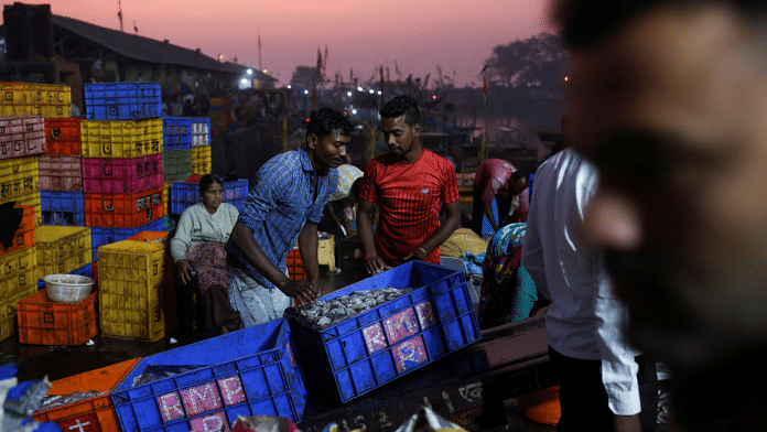 Men load containers holding fish onto a cart, at a fish market in Mumbai | Reuters File Photo/Francis Mascarenhas