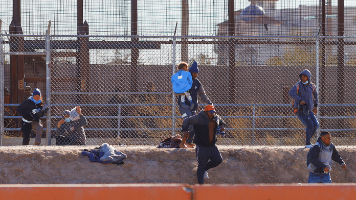 Migrants run to hide from the U.S. Border Patrol and Texas State Troopers after crossing into the United States from Mexico | REUTERS/Jose Luis Gonzalez