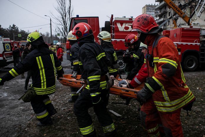 Emergency workers carry a woman released from debris at the site where an apartment block was heavily damaged by a Russian missile strike, amid Russia's attack on Ukraine, in Dnipro, Ukraine on Friday | Reuters
