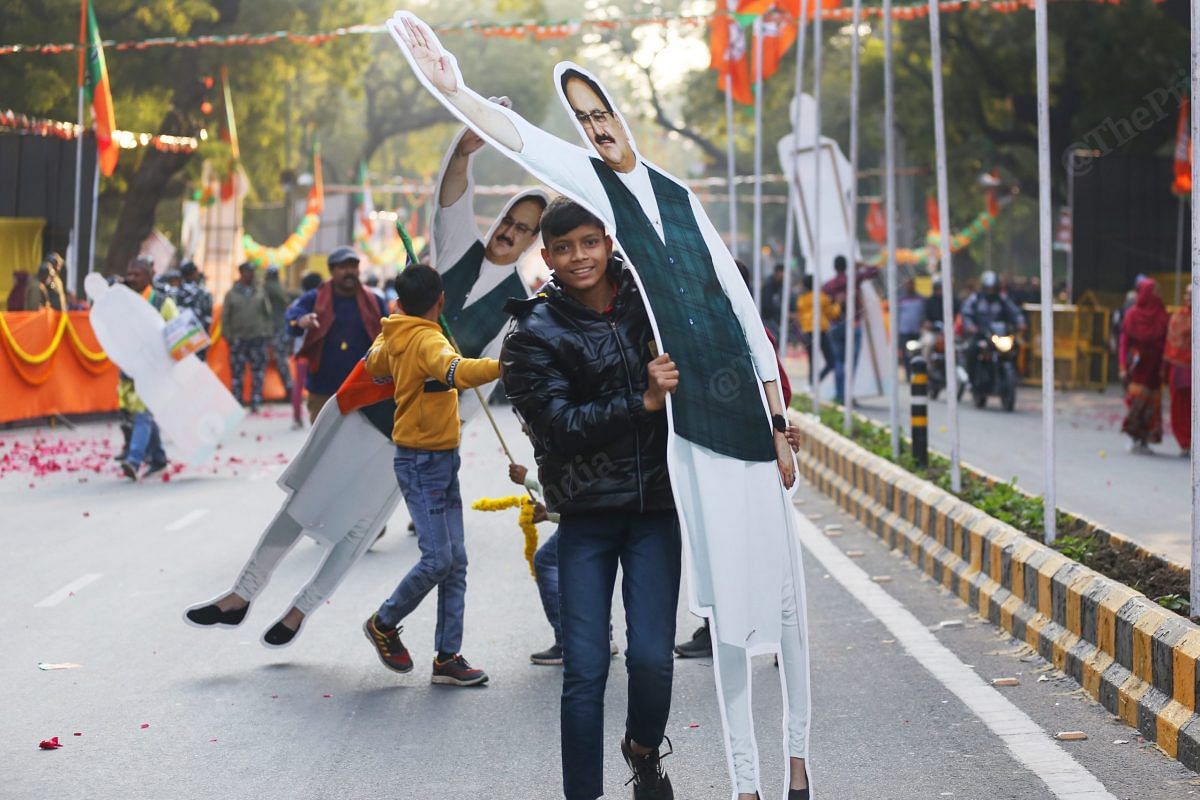 BJP supporters carry cut outs of Nadda after the road show | Photo: Praveen Jain | ThePrint