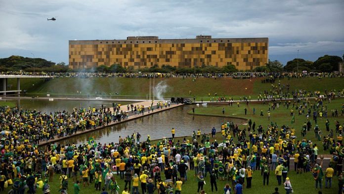 Supporters of Brazil's far-right former President Jair Bolsonaro who dispute the election of leftist President Luiz Inacio Lula da Silva gather near Brazil's Congress after protesters had invaded the building as well as the presidential palace and Supreme Court, in Brasilia, Brazil 8 January 2023 | Reuters/Antonio Cascio