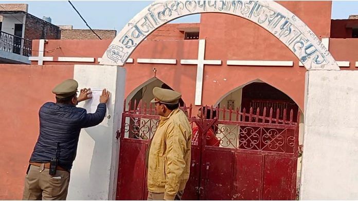 Policemen paste notice on wall of Evangelical Church of India, Fatehpur | Special Arrangement