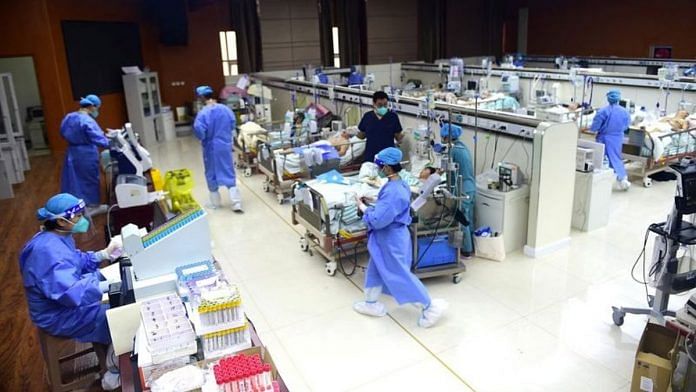 Medical workers attend Covid patients at an ICU, converted from a conference room, at a hospital in Cangzhou, Hebei province, China, on 11 January 2023 | Reuters