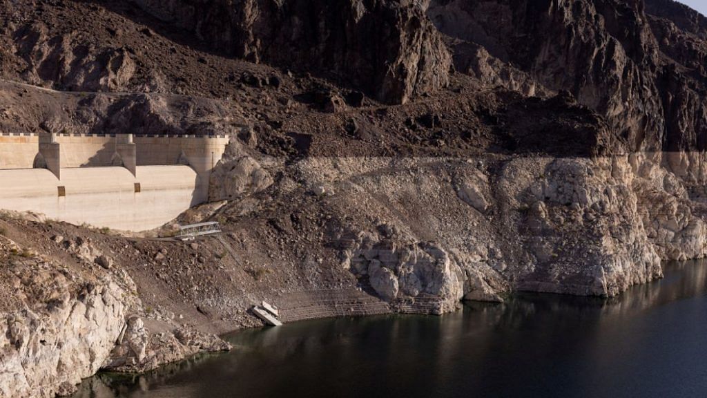 File photo of a dry spillway at Hoover Dam, and stairs ending on a cliff are seen next to the growing ring around Lake Mead, where water levels have declined dramatically to lows not seen since the reservoir was filled after the construction of Hoover Dam, as climate change and growing demand for its water shrink the Colorado River and create challenges, in Boulder City, Nevada, US | Reuters/Caitlin Ochs
