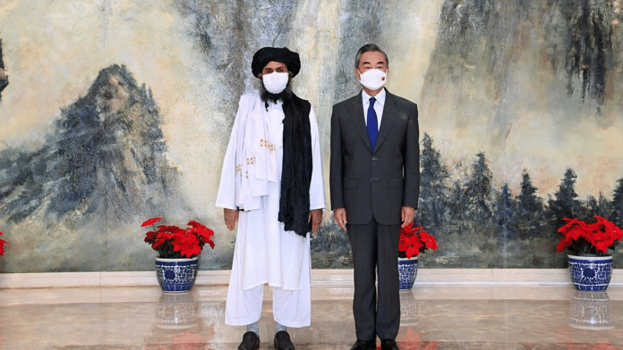 Chinese State Councilor Wang Yi with Mullah Abdul Ghani Baradar, acting first deputy prime minister in Afghanistan's Taliban | Li Ran/Xinhua via REUTERS