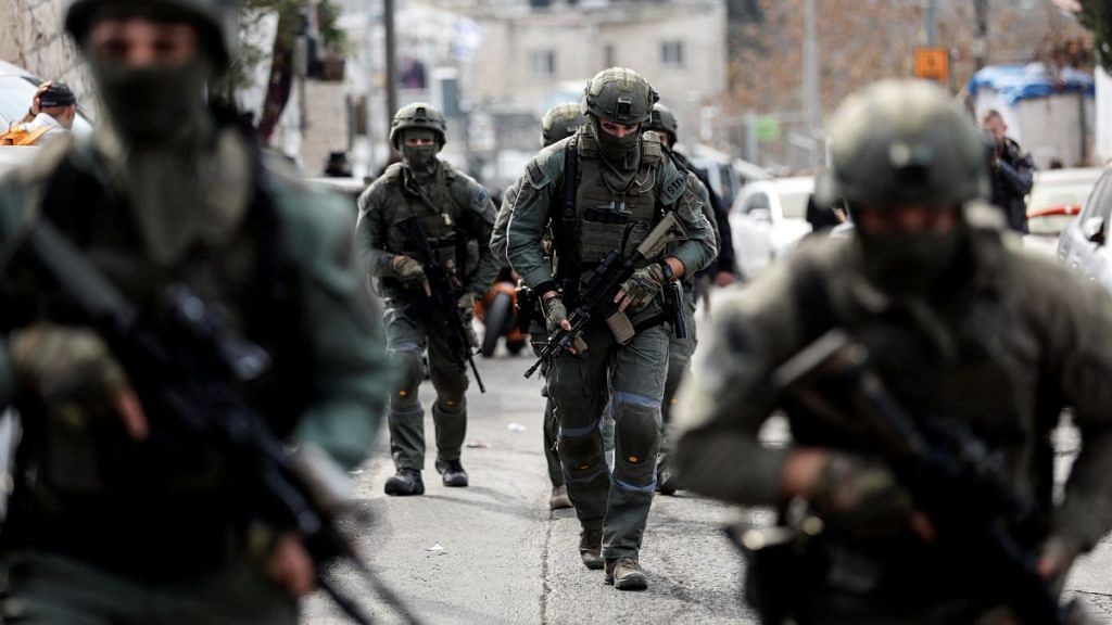 Israeli security personnel work at a scene where a suspected incident of shooting attack took place, police spokesman said, just outside Jerusalem's Old City 28 January 2023 | Reuters/Ammar Awad