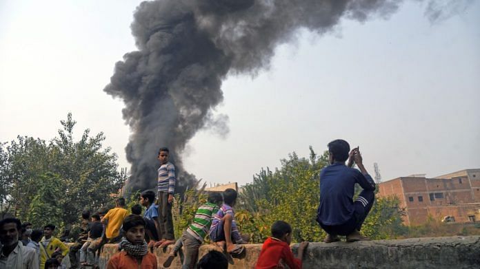 File photo of smoke rising from burning of plastic garbage near Mundka in Delhi | ANI
