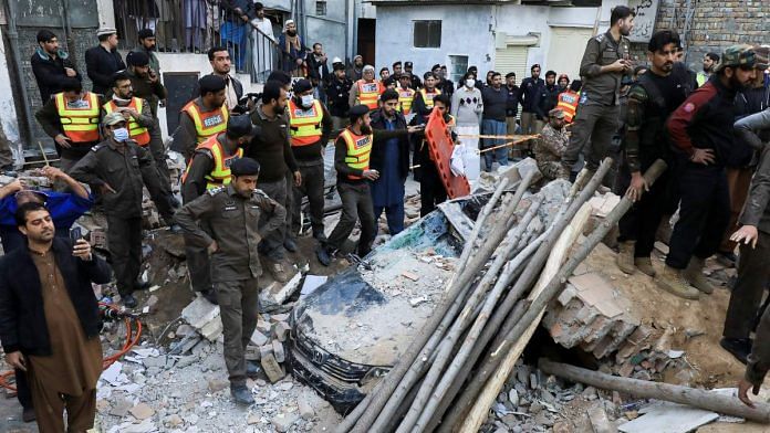 People and rescue workers gather amid the damages, after a suicide blast in a mosque in Peshawar, on 30 January 2023 | Reuters/Fayaz Aziz