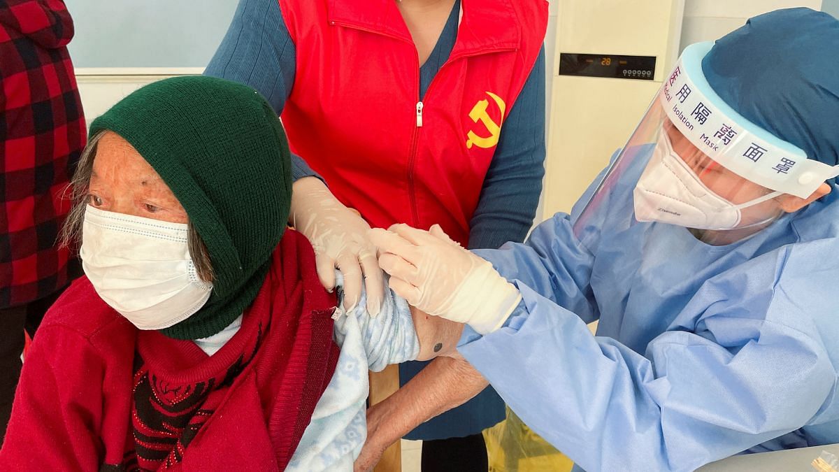 A medical worker administers a dose of a vaccine against coronavirus disease (COVID-19) to an elderly resident, during a government-organized visit to a vaccination center in Zhongmin village on the outskirts of Shanghai, China| REUTERS/Brenda Goh