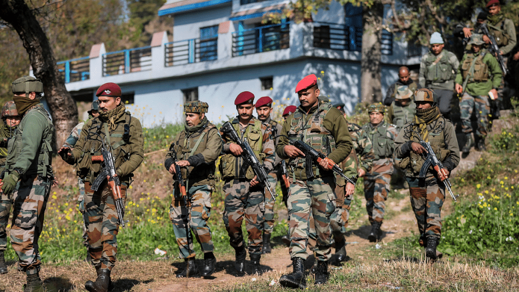 Army personnel near the house where a blast took place at Upper Dangri village in Rajouri district | PTI photo