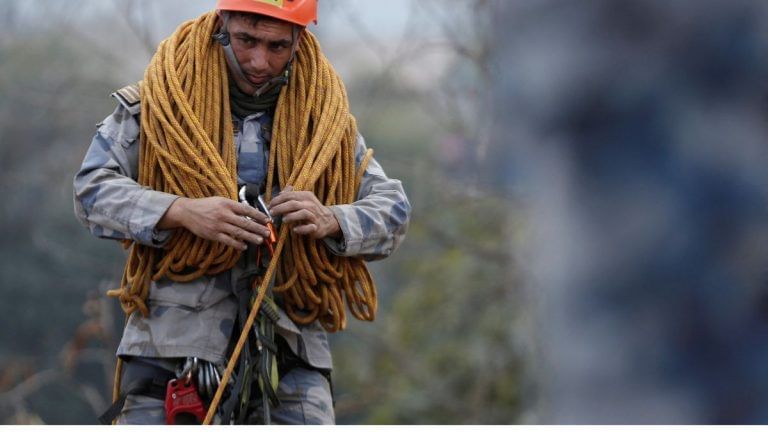 Nepal plane crash searchers rappel, fly drones to find last passengers