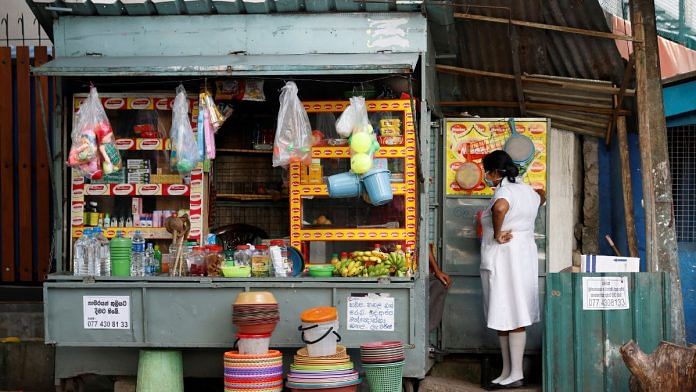 File photo of a medical worker and a vendor selling household goods and food for patients and their family members, outside Apeksha Hospital, Colombo, Sri Lanka on 11 August, 2022. | Reuters