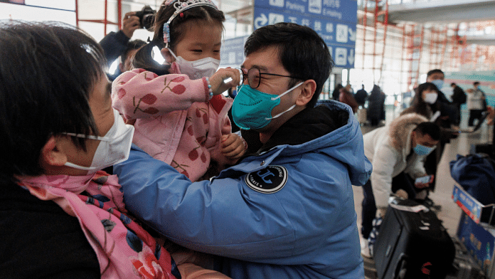 People embrace at the international arrivals gate at Beijing Capital International Airport after China lifted the Covid-19 quarantine requirement for inbound travellers in Beijing | Reuters/Thomas Peter