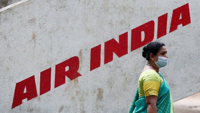 A woman walks past Air India airlines branding in Mumbai | Reuters file photo/Francis Mascarenhas
